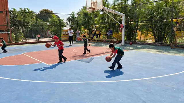 Students playing basketball on the school court at DPS Chhindwara