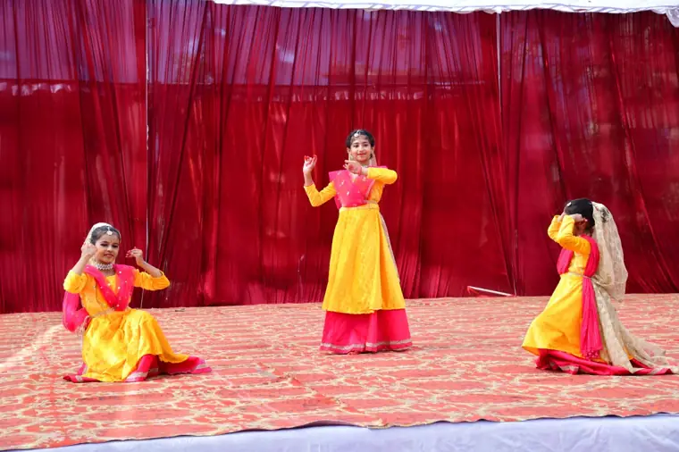 Students performing a dance on stage at DPS Chhindwara