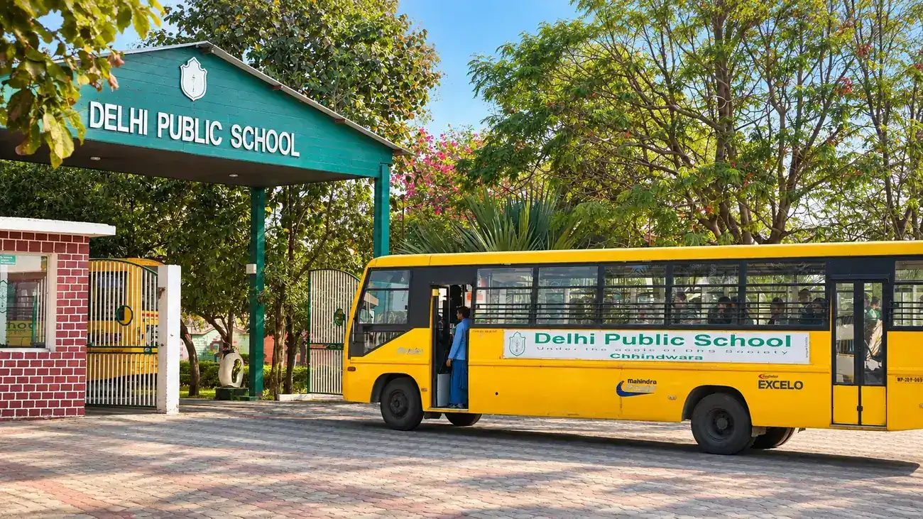 The entrance of Delhi Public School Chhindwara with a school bus